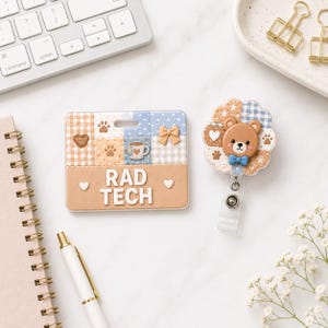 May include: A rectangular ID badge holder and a circular retractable badge reel. The holder features a tan base with the text RAD TECH, decorated with blue and tan gingham, paw prints, a bow, and a coffee cup. The reel features a brown bear.