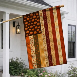 May include: A vertical garden flag featuring a pattern inspired by the American flag, with a canton filled with orange pumpkins and stripes composed of autumn-themed fabrics including fall leaves, orange gingham, and floral vine motifs.