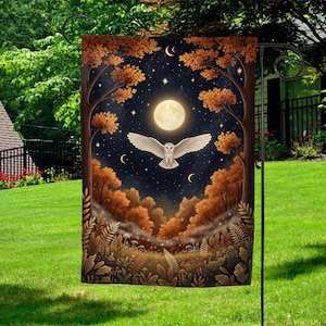 May include: A garden flag featuring a nighttime forest scene with a full moon, stars, and a white owl in flight. The trees have orange foliage, and the overall design evokes a mystical, natural theme.