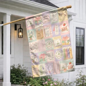 May include: A rectangular garden flag featuring a grid pattern of pastel-colored squares with illustrations of books, flowers, cakes, and reading-themed text. The design includes motifs like stacks of books, open journals, and glasses on a light background.