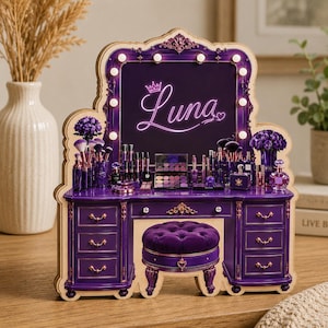 May include: A purple vanity with a mirror, drawers, and a matching stool. The mirror has the name "Luna" in neon. The vanity is decorated with makeup, brushes, and flowers. The vanity is made of wood and has gold accents.