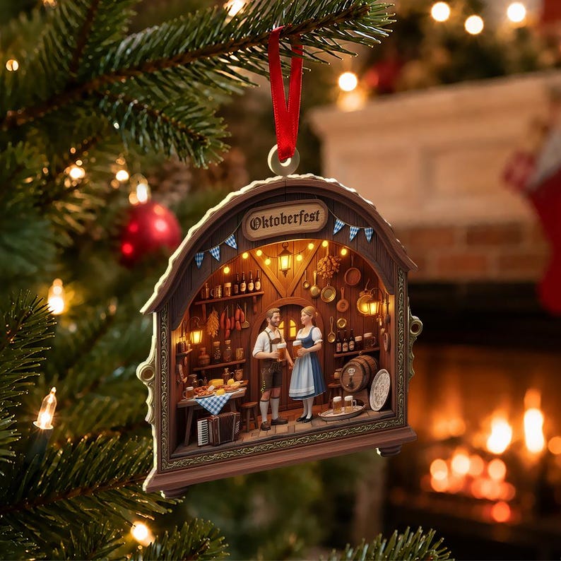 May include: A decorative arched Christmas ornament featuring a detailed 3D scene of a tavern interior with the text Oktoberfest. The scene includes two figures in traditional attire holding beer mugs, surrounded by wooden shelves, barrels, and food.