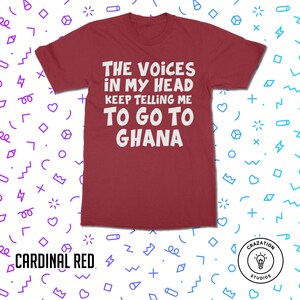 May include: A maroon t-shirt with white text that reads "The Voices in My Head Keep Telling Me To Go To Ghana".