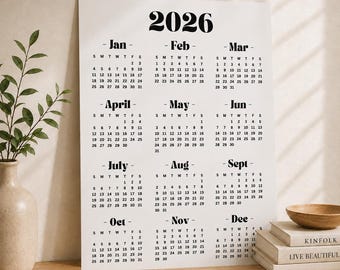 May include: A white wall calendar for the year 2026 featuring black serif typography. The calendar displays all twelve months from January to December in a grid layout, with each month listing the days of the week and corresponding dates.