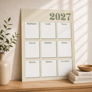 May include: A beige 2027 wall calendar featuring a grid of nine white rectangular sections with green headings: Highlights, Goals, Firsts, Travel, Hobbies, Books, Movies, Quotes, and Favorites. The calendar has a clean, organized layout.