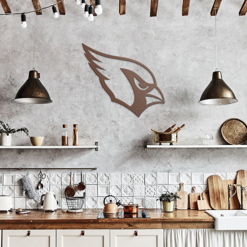 May include: A brown metal cardinal bird silhouette wall decor hanging on a gray wall in a kitchen with white tile backsplash, wooden shelves, and pendant lights.