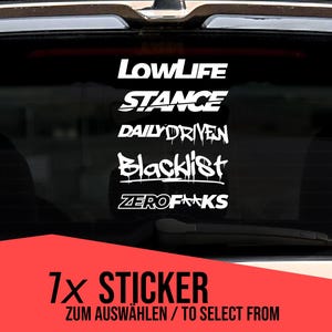 May include: A selection of white vinyl car stickers with phrases like "LOWLIFE", "STANCE", and "DAILYDRIVEN" are displayed on a car window. A red rectangle at the bottom reads "7x STICKER" and "ZUM AUSWÄHLEN / TO SELECT FROM".