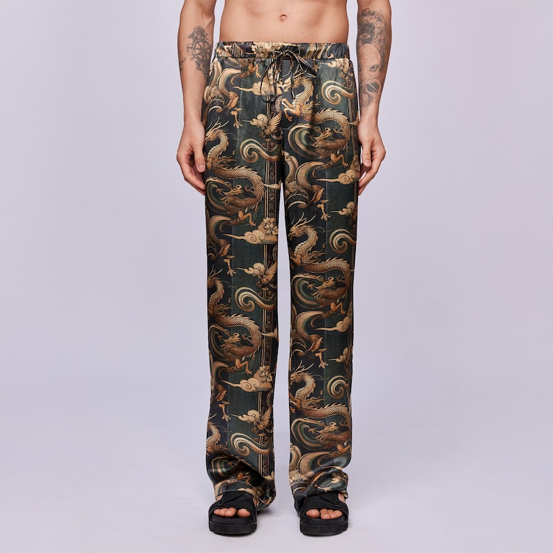 May include: Dark green pants with a repeating pattern of gold dragons and clouds. The pants have a drawstring waist and a relaxed fit. The fabric has a silky sheen. The pants are a unique and eye-catching piece of clothing.