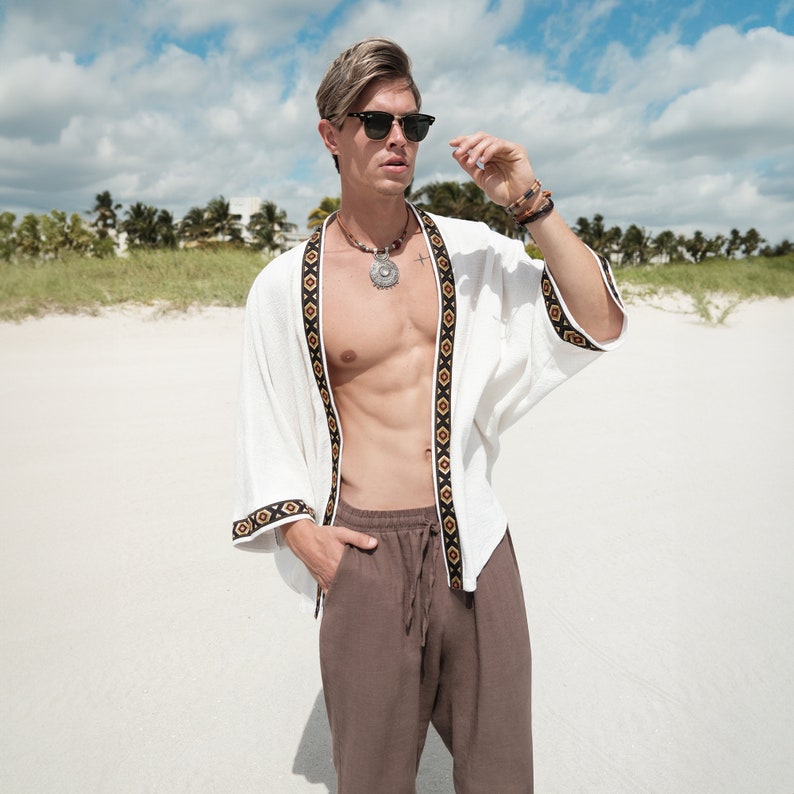 Africano-inspired men’s kimono jacket, perfect for beachwear, festivals, and casual outings. Bold, unique design made from natural fabrics. Lightweight, breathable, and ideal for warm weather. Stand out with this retro-style piece.