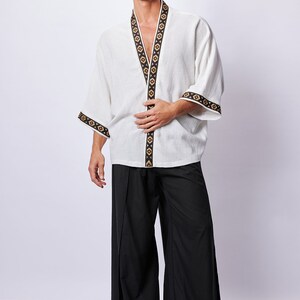 Africano-inspired men’s kimono jacket, perfect for beachwear, festivals, and casual outings. Bold, unique design made from natural fabrics. Lightweight, breathable, and ideal for warm weather. Stand out with this retro-style piece.v