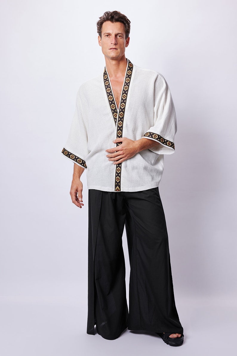 Africano-inspired men’s kimono jacket, perfect for beachwear, festivals, and casual outings. Bold, unique design made from natural fabrics. Lightweight, breathable, and ideal for warm weather. Stand out with this retro-style piece.v