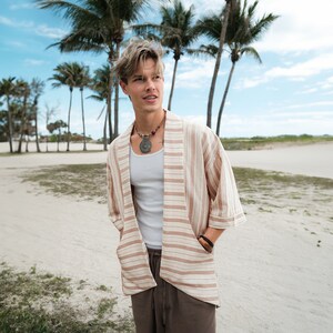 Men's retro linen kimono, perfect for beach parties and music festivals. Lightweight and breathable, offering comfort and style. The unique design stands out in any crowd. Made from high-quality linen, ideal for those who embrace vintage fashion.