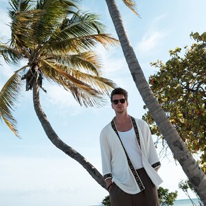 Africano-inspired men’s kimono jacket, perfect for beachwear, festivals, and casual outings. Bold, unique design made from natural fabrics. Lightweight, breathable, and ideal for warm weather. Stand out with this retro-style piece.