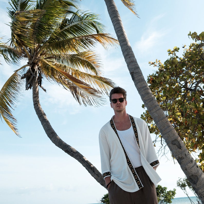 Africano-inspired men’s kimono jacket, perfect for beachwear, festivals, and casual outings. Bold, unique design made from natural fabrics. Lightweight, breathable, and ideal for warm weather. Stand out with this retro-style piece.