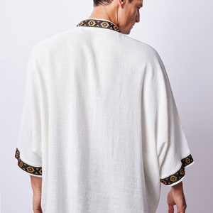 Africano-inspired men’s kimono jacket, perfect for beachwear, festivals, and casual outings. Bold, unique design made from natural fabrics. Lightweight, breathable, and ideal for warm weather. Stand out with this retro-style piece.