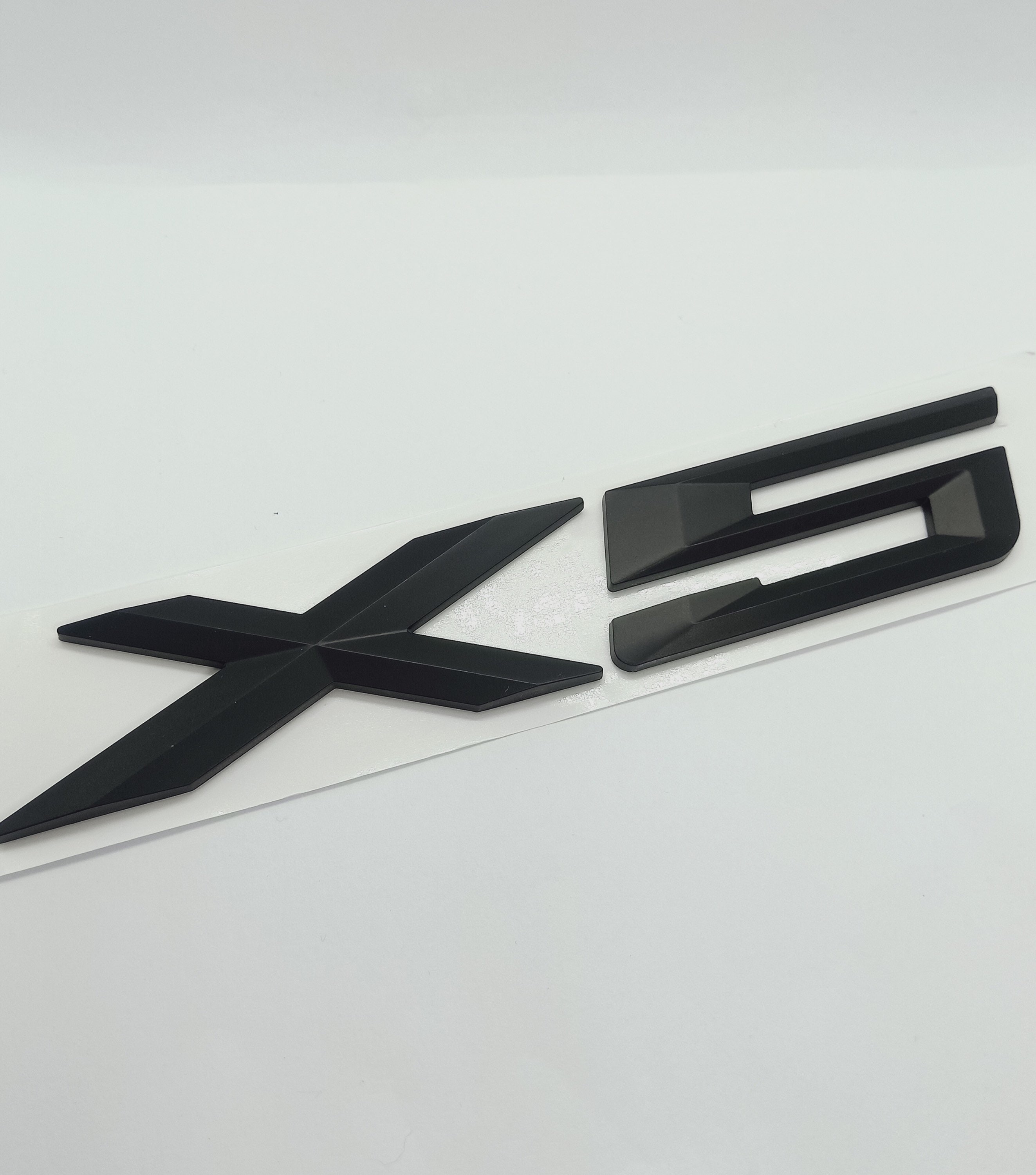 X5 trunk emblem - .de