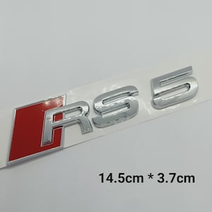 K&ouml;nnte beinhalten: Ein Chrom-RS 5-Emblem mit rotem Hintergrund. Das Emblem ist 14,5 cm x 3,7 cm gro&szlig;.