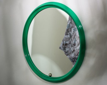Round vintage mirror in a frame of lacquered solid wood, Luxus, designed by Uno and Östen Kristiansson in the 1960s.
