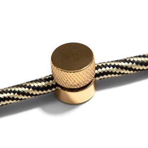 Wall mounting, metal cable clip for fabric cables, Lamp wire decentraliser Brass