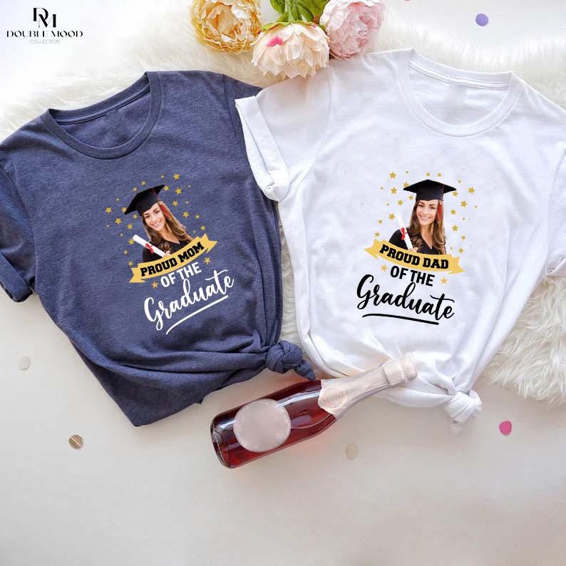 May include: Two white t-shirts with a photo of a graduate and the text "Proud Mom of the Graduate" and "Proud Dad of the Graduate".