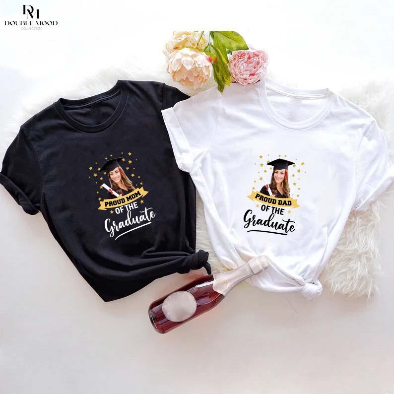 May include: Two black and white t-shirts with a photo of a graduate and the text "Proud Mom of the Graduate" and "Proud Dad of the Graduate".