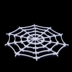 May include: White plastic spider web decoration. The web is made of interlocking pieces that form a circular shape.