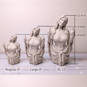 May include: Three off-white female busts in different sizes, each with long hair, wearing a draped top and skirt, and gesturing with both middle fingers raised. The sizes are labeled as Regular 6 inches, Large 8 inches, and XL 12 inches.