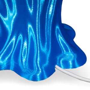 May include: A blue 3D printed lamp with a wavy, textured surface and a white cord.