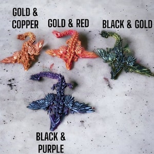 May include: Four origami dragons in different color combinations: gold and copper, gold and red, black and gold, and black and purple.