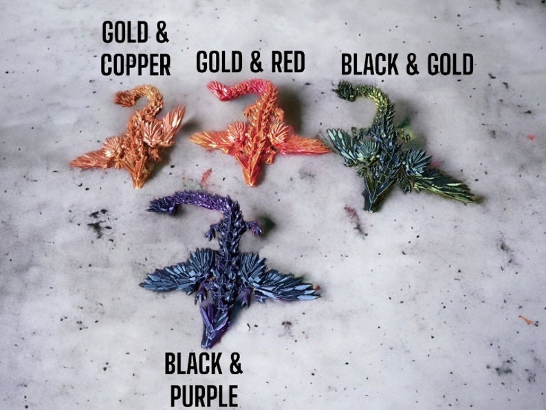 May include: Four origami dragons in different color combinations: gold and copper, gold and red, black and gold, and black and purple.
