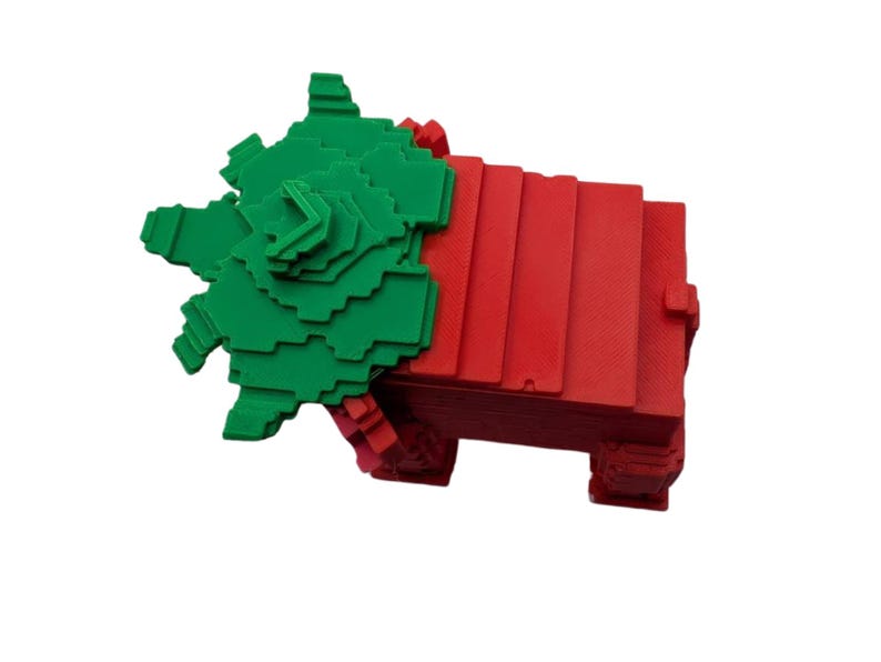May include: A 3D-printed geometric sculpture in red and green. The sculpture features a stacked rectangular base in red, with a green, layered, star-like shape on top. The design is modern and abstract, suitable for home decor.