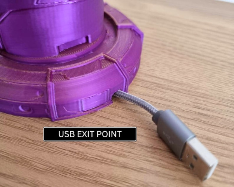 May include: A purple 3D printed base with a USB cable exiting from the side. The text "USB EXIT POINT" is printed on the base.