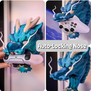 Puede incluir: Un soporte de pared de cabeza de drag&oacute;n azul verdoso con detalles blancos. La boca del drag&oacute;n est&aacute; abierta y sostiene un mando de videojuego blanco. El texto "Auto-Locking Nose" es visible en la imagen.