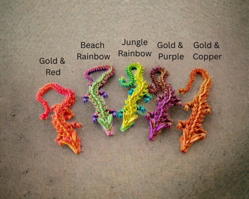May include: Five origami dragons in different colors: gold and red, beach rainbow, jungle rainbow, gold and purple, and gold and copper.