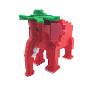 May include: A red, pixelated elephant figurine with a green leafy crown. The elephant has white tusks and pink ears. The toy is made of small, square blocks, giving it a unique, geometric appearance.