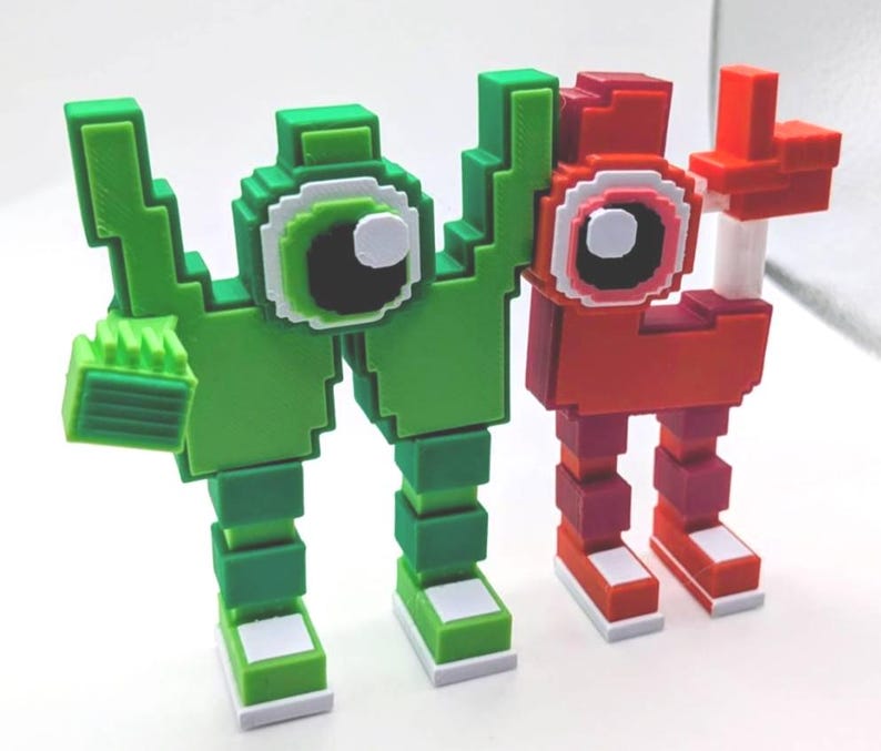 May include: Two pixelated figures, one green and one red, stand side-by-side. The green figure has a blocky arm and a large eye with white, black, and green details. The red figure has a similar design, with a raised arm. Both have blocky legs and feet.