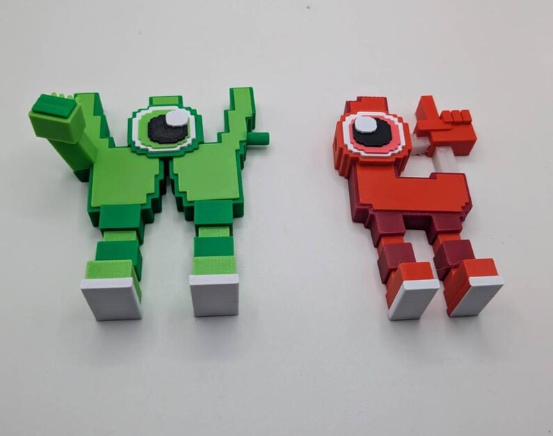 May include: Two pixelated figures, one green and one red, stand side-by-side. The green figure has a large eye and outstretched arm. The red figure has a similar design, with a raised hand. Both figures have white-tipped feet.