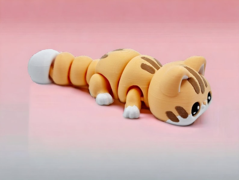 May include: A segmented, orange and white, 3D printed cat figurine with a white tail. The cat is lying on its belly with its head turned to the side.