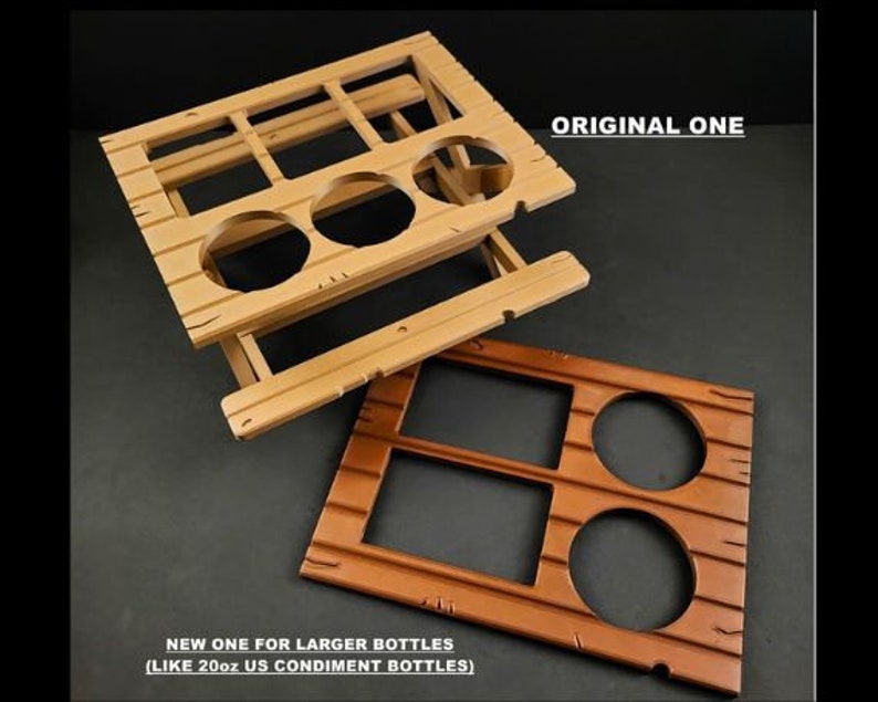 May include: Two wooden bottle holders, one with six slots and the other with three slots. The larger holder is labeled "NEW ONE FOR LARGER BOTTLES (LIKE 20oz US CONDIMENT BOTTLES)". The smaller holder is labeled "ORIGINAL ONE".