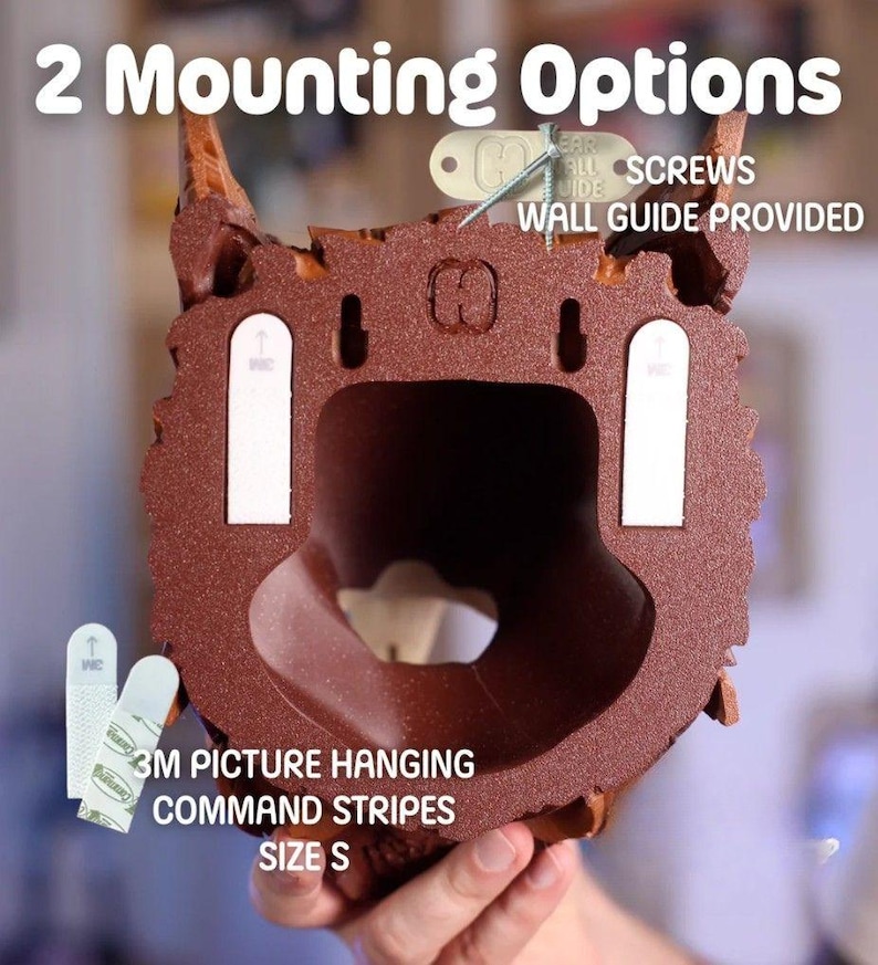 May include: A brown decorative wall hanging with a textured surface. The image shows two mounting options: screws and 3M picture hanging command strips. Text on the image reads "2 Mounting Options", "3M Picture Hanging Command Strips", and "Size S".