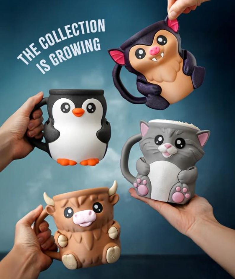 May include: Four ceramic mugs in the shape of animals are displayed. The mugs are a penguin, a bat, a cat, and a highland cow. The penguin is black and white with orange feet. The bat is purple and tan. The cat is gray and white. The cow is brown.