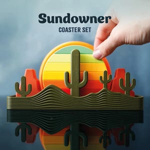 May include: A decorative coaster set with a desert theme. The set includes a round coaster with a sunset design in shades of yellow, orange, and red. The base features a desert landscape with cacti and mountains. The text "Sundowner COASTER SET" is at the top.
