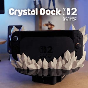 May include: Black Nintendo Switch dock with a crystal-like design. The dock features the text "Crystal Dock 2" and "Nintendo Switch". The base is black and the crystals are white.