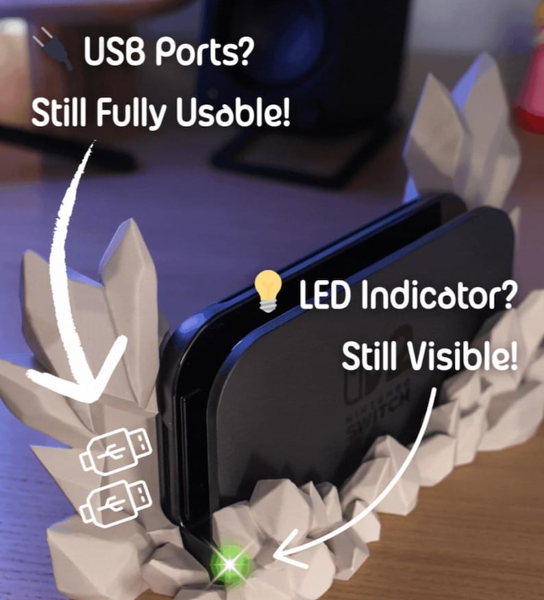 May include: A black Nintendo Switch console sits in a white, rock-like stand. The stand has two USB ports and an LED indicator. Text on the image reads "USB Ports? Still Fully Usable!" and "LED Indicator? Still Visible!"