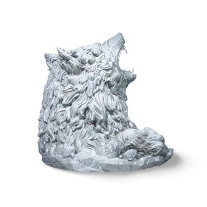 May include: A detailed, gray sculpture of a wolf howling, with intricate fur and facial features. The wolf is positioned on a rocky base, with a second wolf figure lying down. The sculpture is set against a white background.
