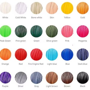 May include: A color chart of 24 different colors of thread, including white, black, red, blue, green, yellow, orange, purple, brown, and gray.