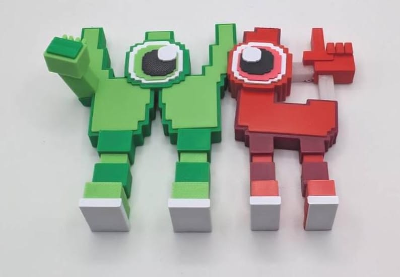 May include: Two pixelated figures, one green and one red, stand side-by-side. The green figure has an arm raised, while the red figure points a finger. Both have large, round eyes and blocky features, reminiscent of retro video game characters.
