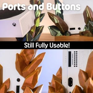 May include: White gaming console with a decorative crystal-like stand. The stand is multi-colored with shades of brown, green, and gold. The text "Ports and Buttons" and "Still Fully Usable!" are visible.
