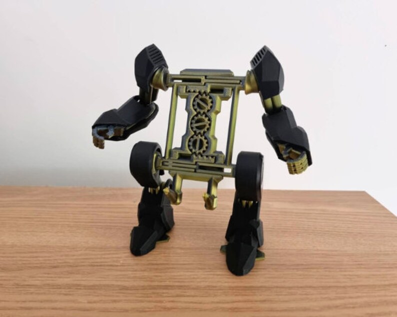 May include: A black and gold 3D printed robot with articulated arms and legs. The robot has a gear-like design on its torso.