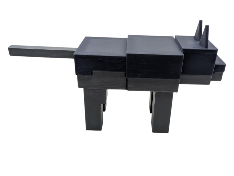 May include: A black, geometric sculpture of an animal, possibly a cat or dog, with a long tail and upright ears. The sculpture is constructed from stacked rectangular blocks and stands on four legs. The design is modern and minimalist.
